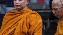 Buddhist monks hold prayers at site of building that collapsed in Bangkok during earthquake