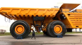 Belarus: David vs Goliath Reimagined. Man Tiny Next to Mammoth BELAZ in Jaw-Dropping Showdown