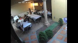 Woman gracefully battles gusty surprise while saving the dessert