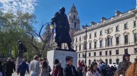 Trans activists make their feelings known  in Parliament Square as trans flag is attached to statue of Churchill
