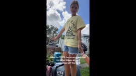 Driver unfazed as person falls with bags in Auckland