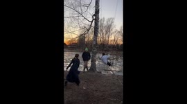 Village Girls Play On Rope Swing Over Water
