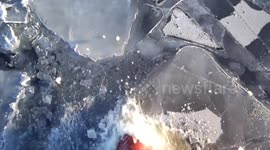 Ship is making way by breaking ice in North Atlantic winters