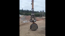 Riding tires with a crane arm at a recycling site in Borlänge
