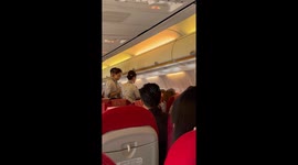 Angry passengers have to be calmed down by air hostess on flight in China