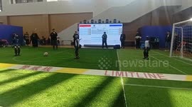 Robots play football against each other in China