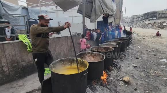 Gaza Strip, Palestine: Palestinian children line up for a free meal