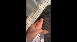 Person removes starfish-shaped earring from foot in San Diego