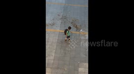 Little boy 'controls wind' as leaves swirl around him like scene from film