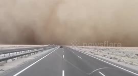 Motorists in Iraq drive in sandstorm seeing their visibility seriously reduced