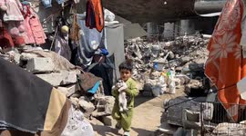 Grieving Gaza father clings to children's belongings after deadly airstrike