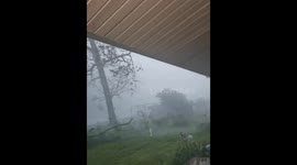 Rain-Wrapped Tornado Passes Just 0.2 Miles from Storm Chaser's Truck, Gusts Hit 102 mph