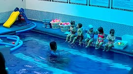 Little boy slips into the pool while trying to comfort his crying mate