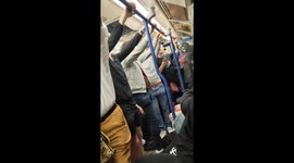 Cheerful Liverpool fans at the underground train singing in London, England