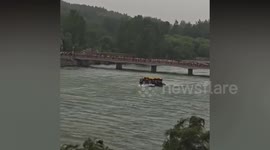 Visitors to ancient riverside Buddhist caves seek tranquility as storm strikes
