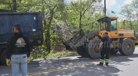 A tri axle is pulled from the wooded area following a crash with confinement