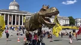 A dinosaur in Trafalgar Square urges people to support the abolishment of the monarchy