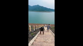 Husband proves to wife he can hop up steps... only to hit his head on sign at the top