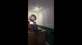 Dart hits hand during risky throw in Quedgeley, England, UK