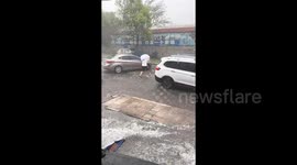 Shop owner rescues boy stranded in hailstorm on his way home from school