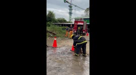 Hilarious moment intern topples on ground when she loses balance unrolling fire hose
