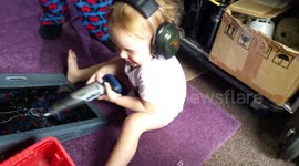 1 and a half year old girl taking after her dad!