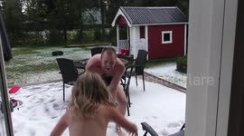 Family play in hail after heavy storm