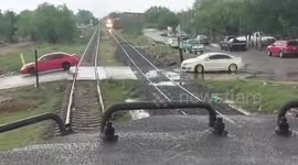 Car stuck on railway tracks is hit by cargo train