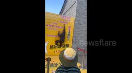 Man testing how high he can jump ends up diving through backdrop leaving crowd in stitches