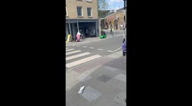 Man Drives Toy Car On London Sidewalk