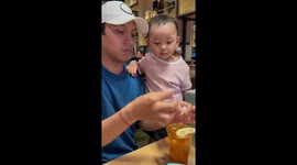 Toddler munches on lemon only to spit it out when sour taste hits her