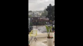 Bin glides through Santa Ponsa's flooded street during flash flood