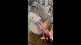 Adorable moment 15-month-old toddler embraces Eeyore at Walt Disney Resort