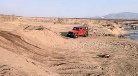 Toy car tackles slope in off-road field in Hebei, China