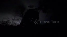 US: Lightning flashes in the night sky during tornado warned storm in Norton Shores