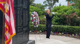 Woman performs TAPS during an event to honor fallen U.S. Service members