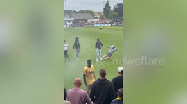 Moment footy fan takes down goading rival - with perfect slide tackle