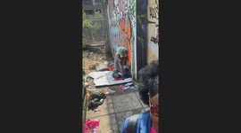 Easy-going man turns his jeans into shorts to combat the heat during Notting Hill Carnival