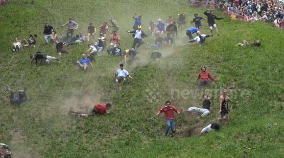 Thrillseekers throw themselves off Cooper's Hill as UK’s Cheese Rolling contest takes place