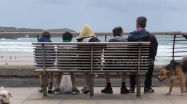 UK Weather. Half term visitors hunker down with wind, showers and sunshine forecast. Fistral, Cornwall, UK
