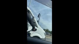 Rude biker crashes into railing after heated confrontation with a van driver