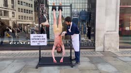 'Skinned' PETA activist strung up outside clothes store in grisly anti-leather protest