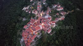 A stunning small croatian village on the coast is filmed with a drone while the sun is going down