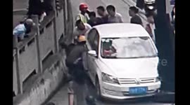 Woman pinned to wall after car driving along pavement crashes into lamppost