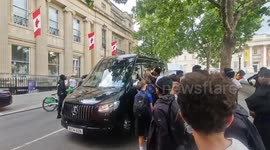 Eager teens run after van during a clothing drop in Trafalgar Square