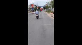 It's Dangerous With The Action Of A Motorbike Rider With Both Hands Off In Vietnam