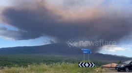 Plume of dark ash clouds rise from Mount Etna as eruptions sends tourists fleeing
