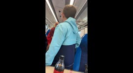 Man climbs onto luggage rack inside public transit in Blackpool, England, UK