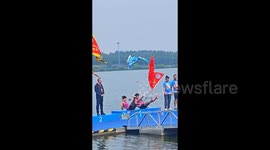 Boat race champions attempt to make cool podium entrance - end up slipping in sync