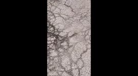 Comical forklift fail as operator struggles to dump scrap metal, resulting in a big mess